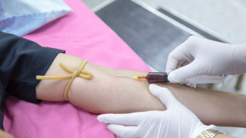 Nurse extracting blood sample.