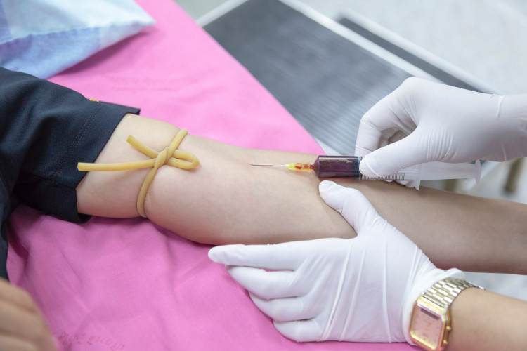 Nurse extracting blood sample.