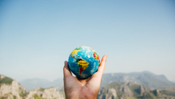 Person holding the globe.