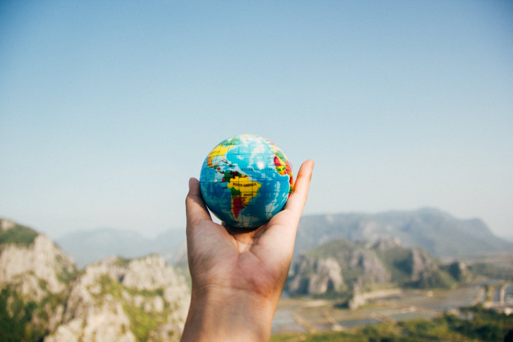 Person holding the globe.
