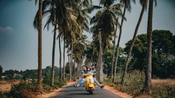 Woman and man riding in a motorcycle.