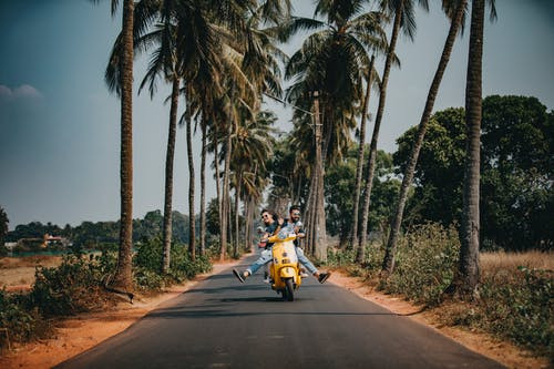 Woman and man riding in a motorcycle.
