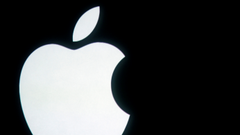 The Apple logo is displayed onstage before a product unveiling event at Apple headquarters in Cupertino