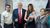 Trump and the first lady with the family and baby son of El Paso shooting victims Jordan and Andre Anchondo.