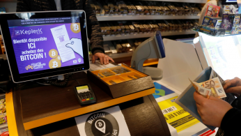 A customer purchases bitcoins sold at a tobacco shop at Rueil-Malmaison, France