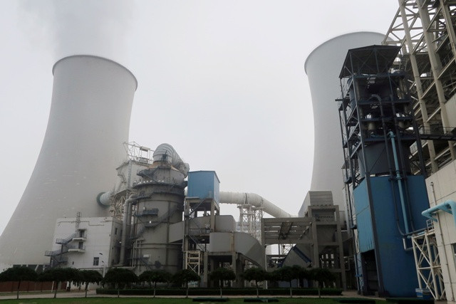 Smoke is seen from a cooling tower of a China Energy ultra-low emission coal-fired power plant during a media tour, in Sanhe