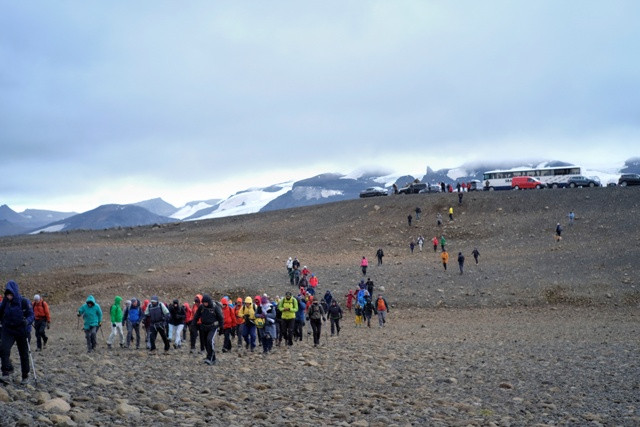 People walk towards Okjokull glacier in Iceland