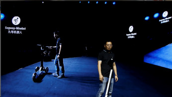 Ninebot President Wang Ye unveils semi-autonomous scooter KickScooter T60 that can return itself to charging stations without a driver, at a Segway-Ninebot product launch event in Beijing