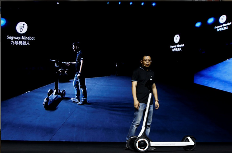 Ninebot President Wang Ye unveils semi-autonomous scooter KickScooter T60 that can return itself to charging stations without a driver, at a Segway-Ninebot product launch event in Beijing