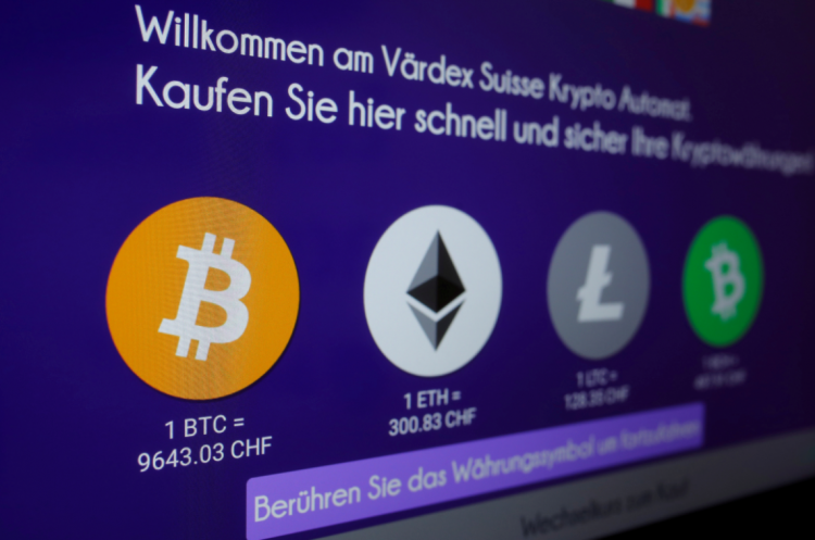 Exchange rates and logos of Bitcoin (BTH), Ether (ETH), Litecoin (LTC) and Bitcoin Cash (BCH) are seen on the display of a cryptocurrency ATM of blockchain payment service provider Vaerdex in Zurich, Switzerland