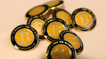 Bitcoin.com buttons are seen displayed on the floor of the Consensus 2018 blockchain technology conference in New York City