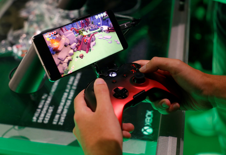 A gamer plays a cloud-based coputer game of Microsoft's Project X Cloud during Europe's leading digital games fair Gamescom