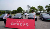 People attend a Tesla performance driving school promotional event at Shanghai International Circuit