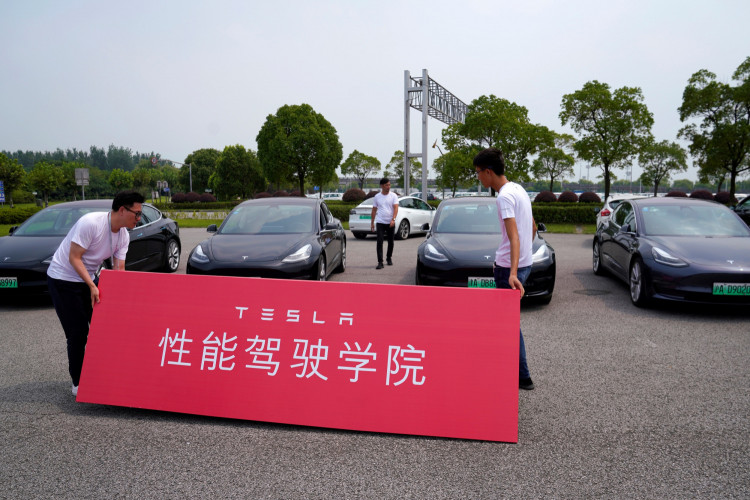People attend a Tesla performance driving school promotional event at Shanghai International Circuit