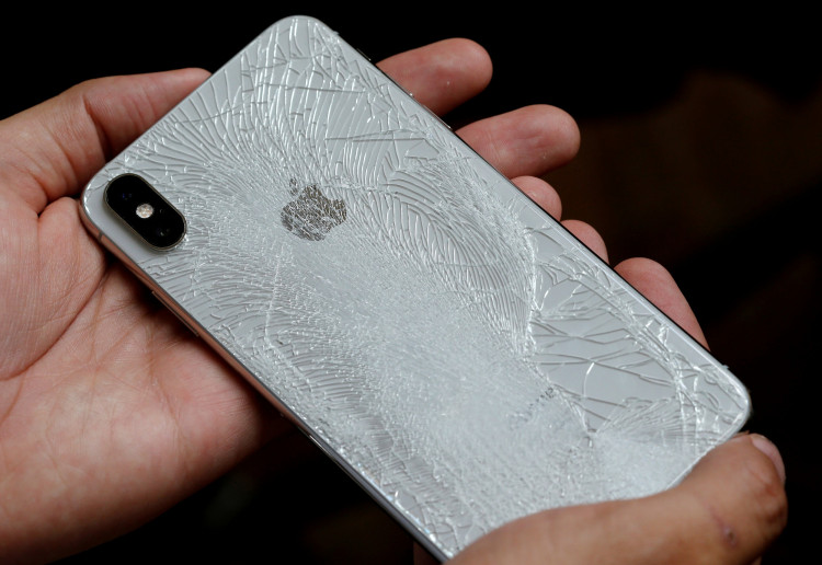 A worker refurbishes an Apple Iphone cell phone at a workshop of the Oxflo company, specialised in refurbishment of broken European smartphones in Lusignac