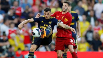 Soccer Football - Premier League - Liverpool v Arsenal - Anfield, Liverpool, Britain - August 24, 2019 Arsenal's Granit Xhaka in action with Liverpool's Adam Lallana REUTERS/Phil Noble