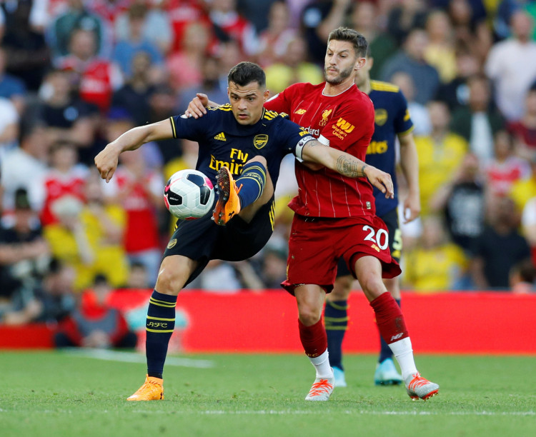 Soccer Football - Premier League - Liverpool v Arsenal - Anfield, Liverpool, Britain - August 24, 2019 Arsenal's Granit Xhaka in action with Liverpool's Adam Lallana REUTERS/Phil Noble
