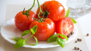 Tomato top of white ceramic plate.