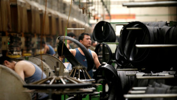 An employee works on the production line of a tyre factory under Tianjin Wanda Tyre Group in Xingtai