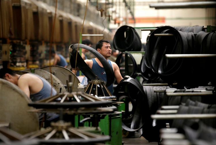 An employee works on the production line of a tyre factory under Tianjin Wanda Tyre Group in Xingtai