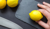 Person slicing a lemon