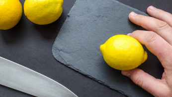 Person slicing a lemon