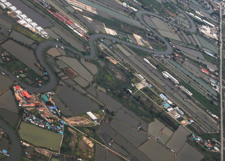 A general view of agricultural land is seen through the window of an airplane of EgyptAir after the rain, over Thailand