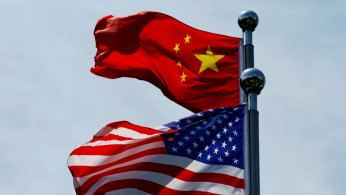 Chinese and U.S. flags flutter near The Bund in Shanghai