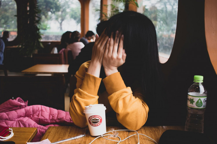 Woman covering her face.