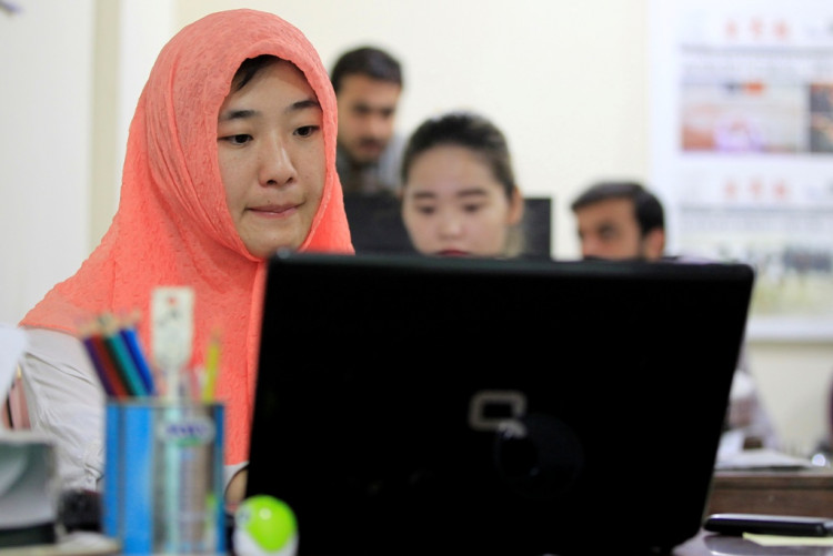 Reporters work at the office of Hushang, a Mandarin language weekly newspaper, in Islamabad
